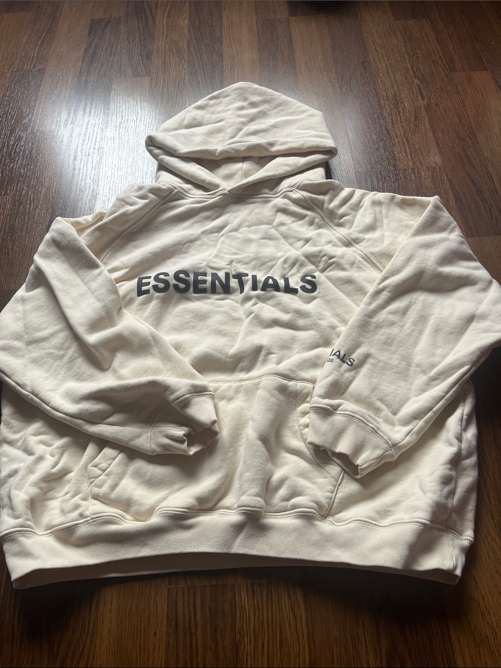Fear of God Essentials Cream Hoodie with Black Chest Logo